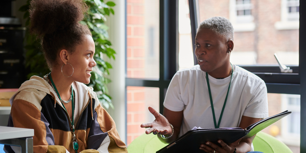 Advisor speaks with college student