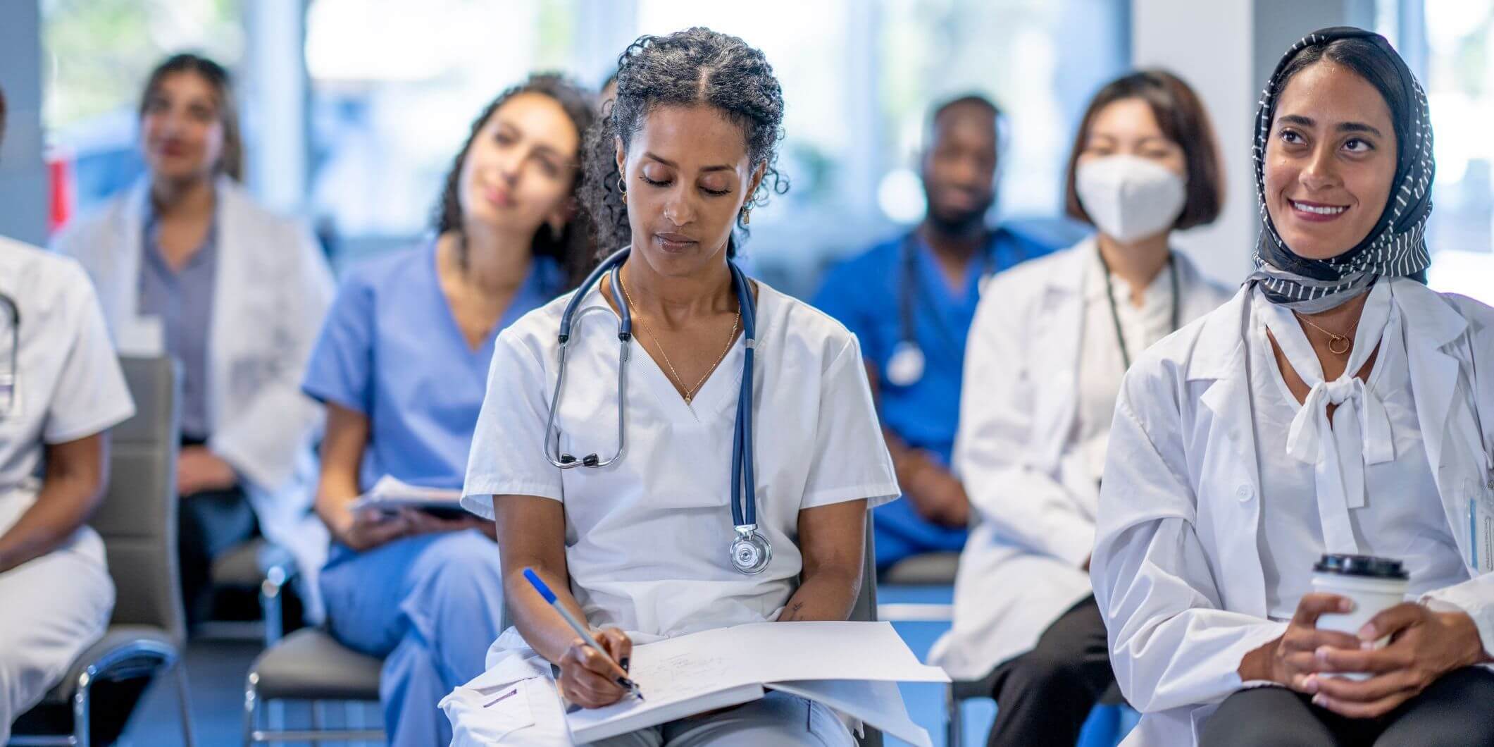 Medical students take notes during a lecture