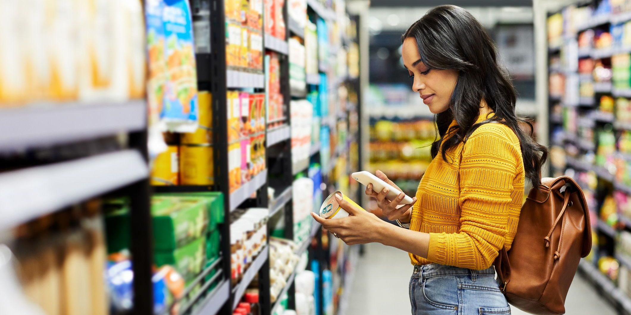 Shot of a young woman shopping for groceries in a supermarket