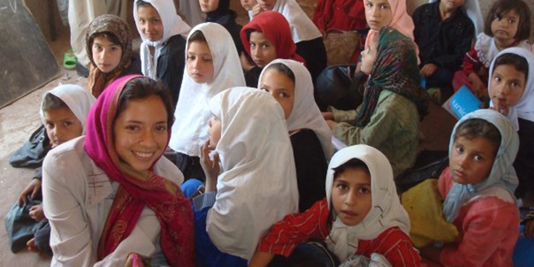 Veronica Minaya smiles with children in Afghanistan
