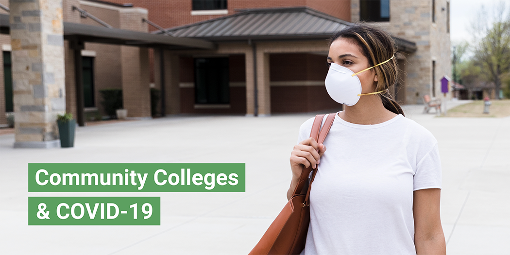 A woman walks on campus wearing a surgical mask