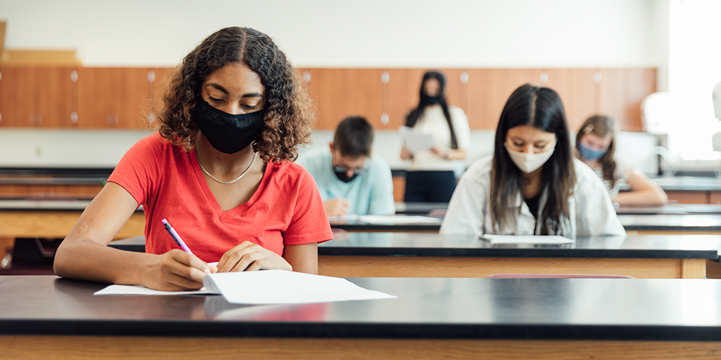 Students in masks sit in class 