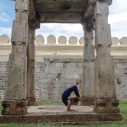 Veronica Minaya in an inverted yoga pose in India